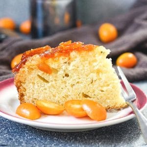 slice of Upside Down kumquat cake with fresh kumquats for garnish