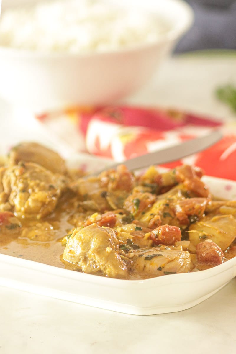 South Indian Chicken Curry with Coconut Milk in a platter with a spoon