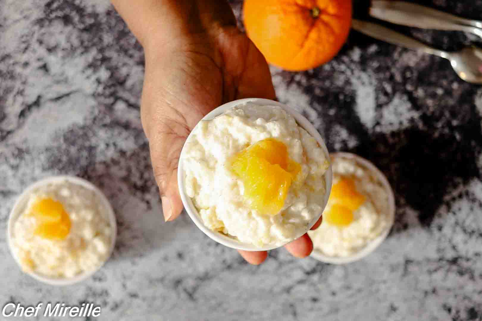 bowl of Norwegian Appelsinris dessert garnished with fresh orange