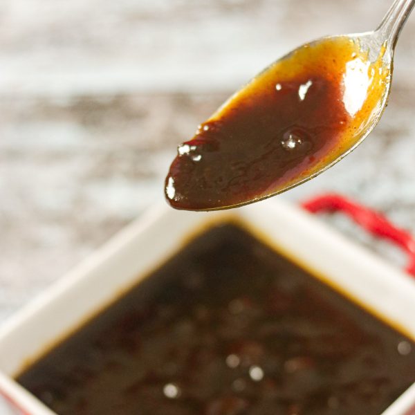 Habanero BBQ Sauce on a spoon over a square bowl