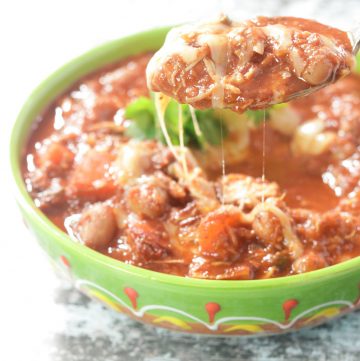 bowl of chicken chili with melted cheese