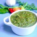 bowl of sofrito marinade with fresh vegetables in background