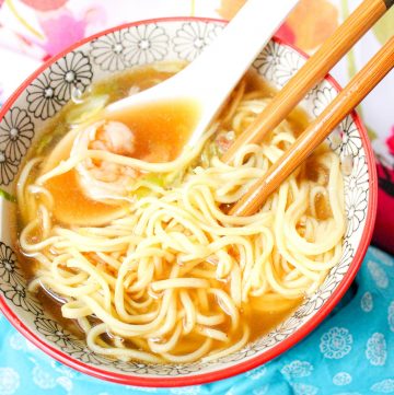 bowl of noodle soup with shrimp and chopsticks