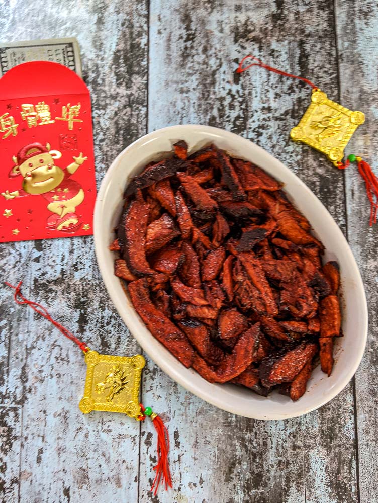 bowl of Char Sui Pork with Chinese New Year decorations