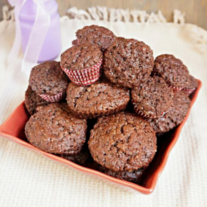 chocolate muffins in a square bowl on a tea towel