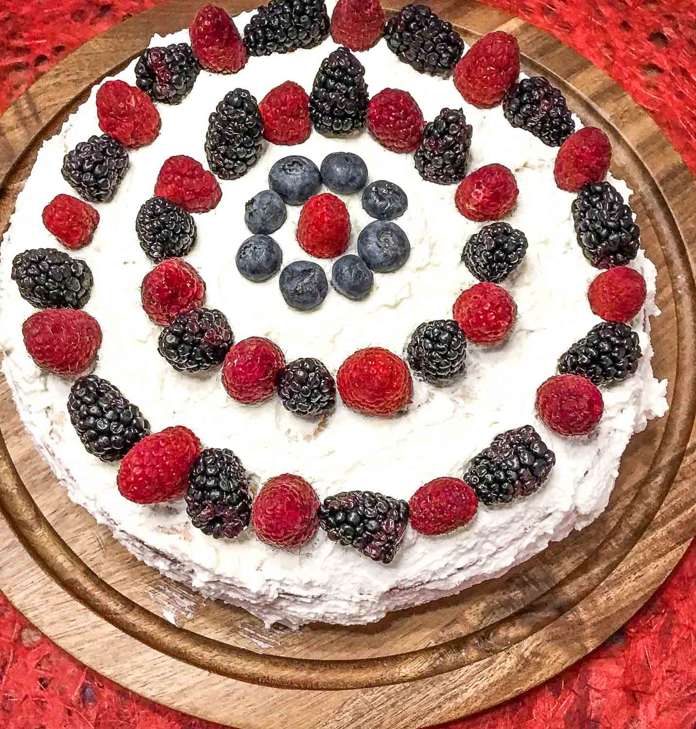 Cream Cake recipe with fresh berries and vanilla custard with whipped cream forsting.