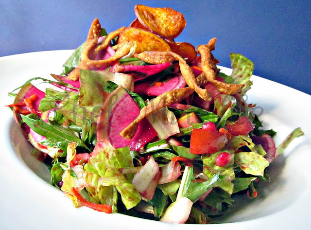 Mizuna Salad with Watermelon Radish and Blackberry Vinagrette garnished with fried noodles