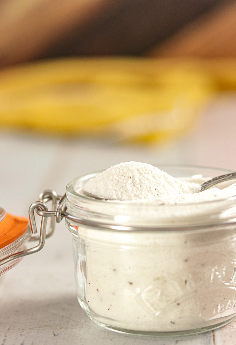 Vanilla Bean Sugar on a spoon over a jar