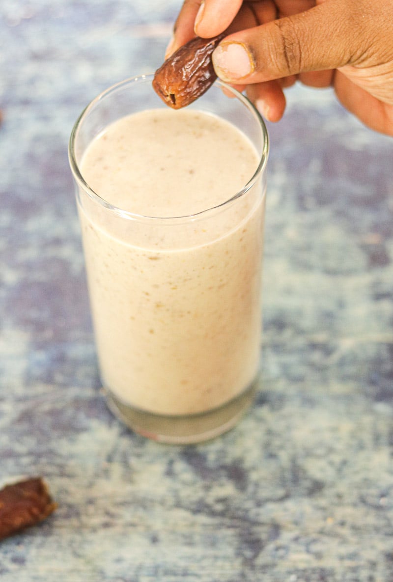 Banana Date Smoothie with hand