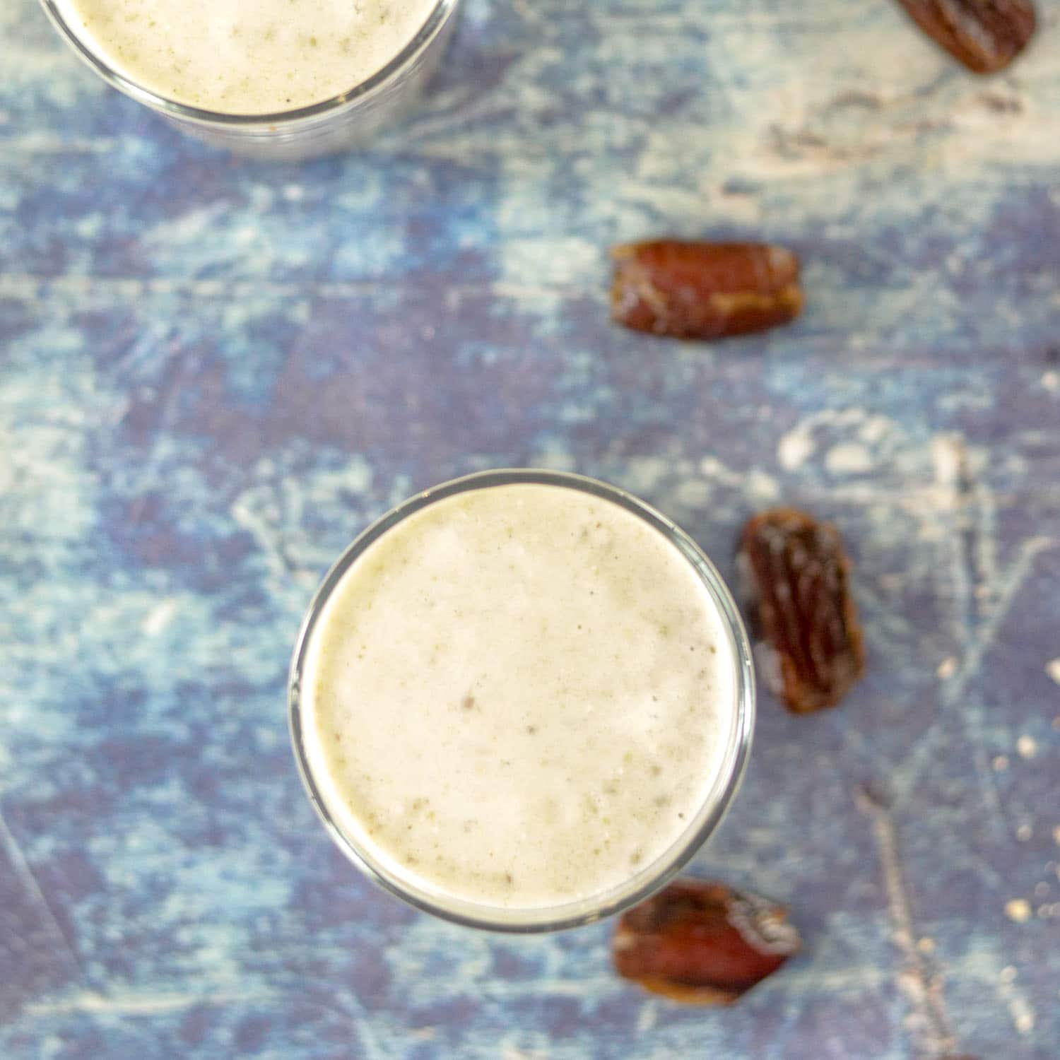 Banana Smoothie with yogurt and dates in the background