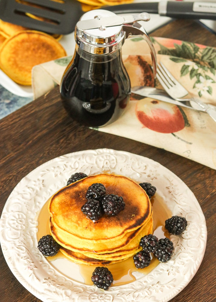 Pumpkin Pancakes on a plate with syrup and blackberries