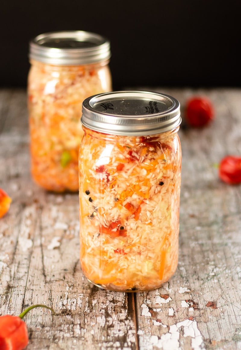 Haitian Pikliz in jars with Scotch Bonnet peppers