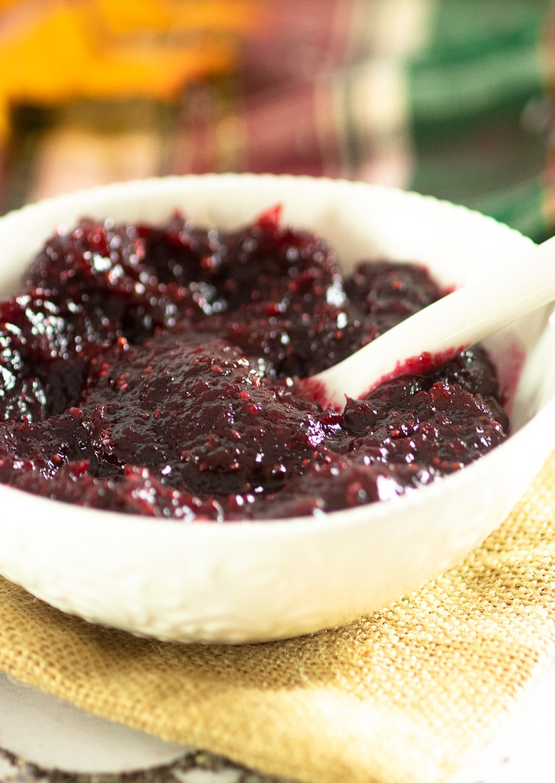 Homemade Cranberry Sauce in a bowl with spoon.