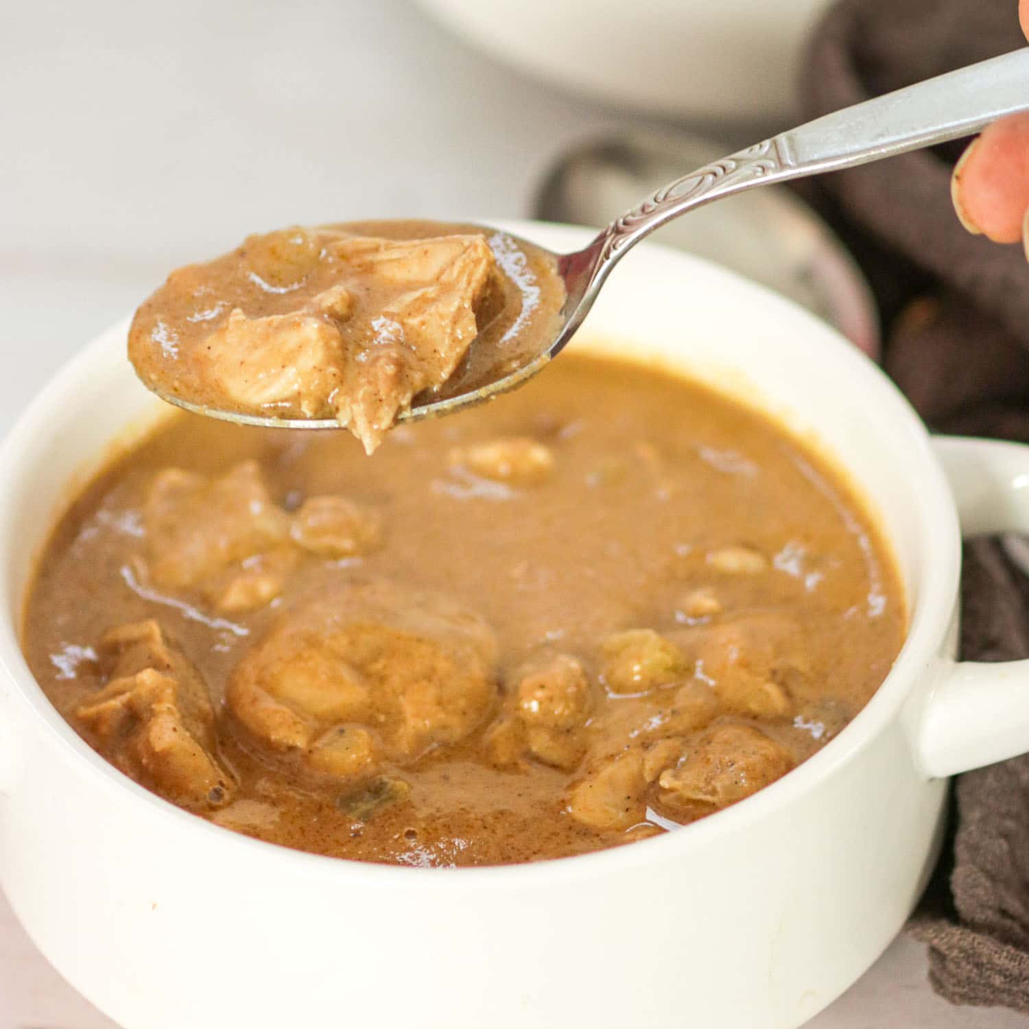 Suriname Style Peanut Soup in a bowl with a spoon