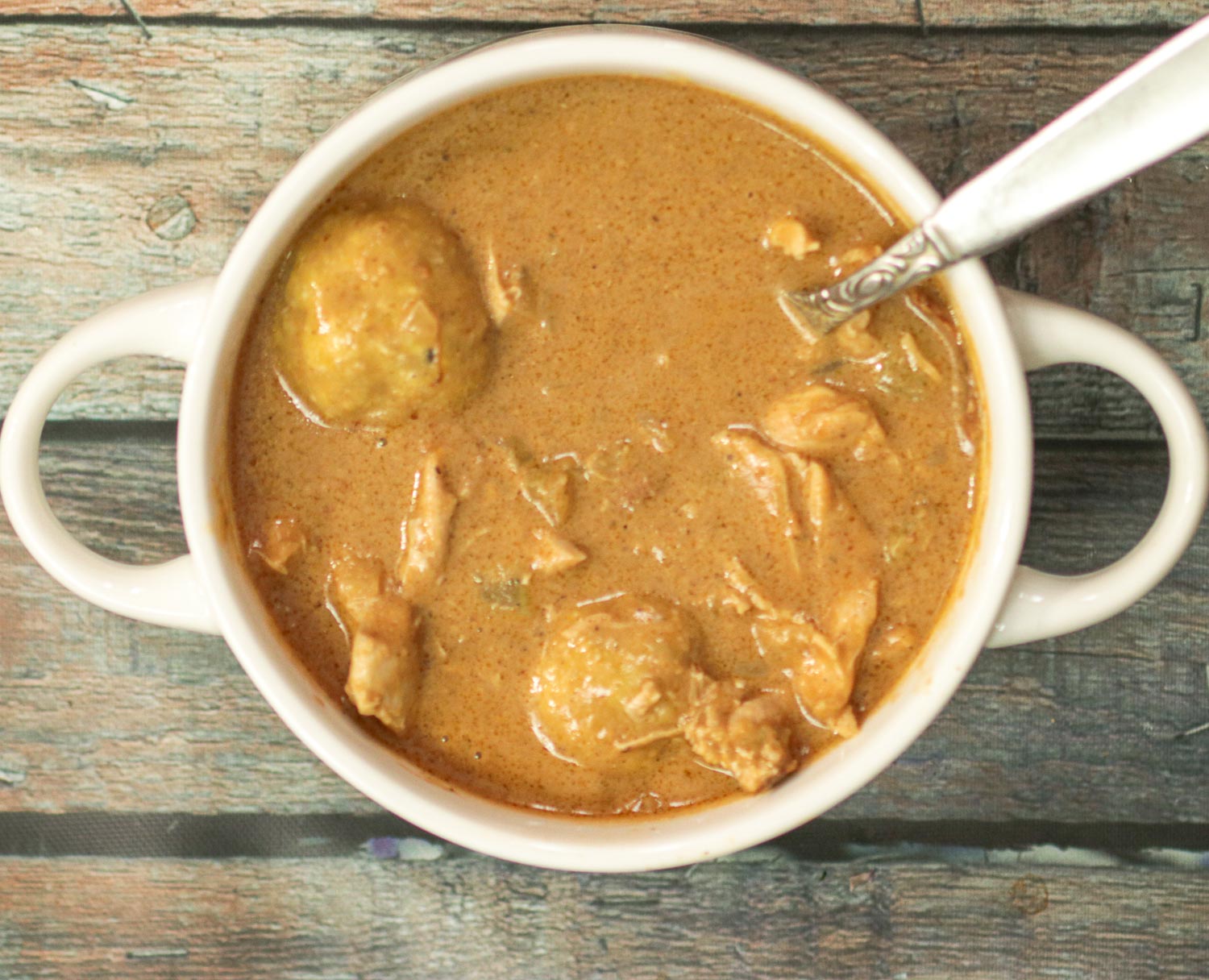 bowl of Peanut Soup with a spoon in it