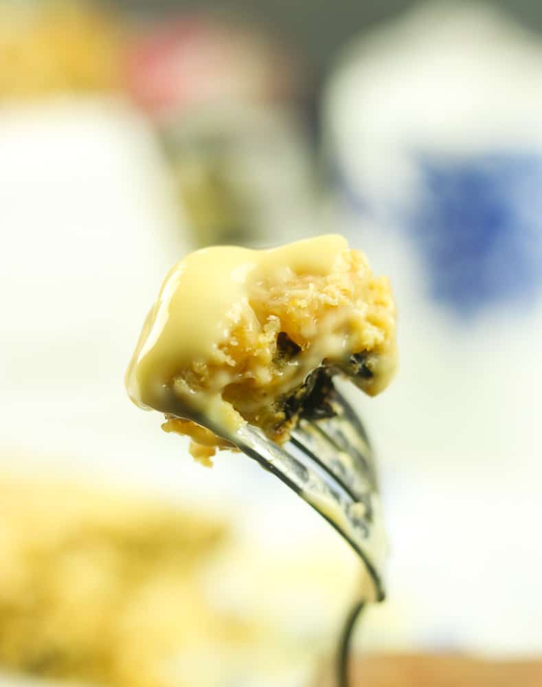 piece of Spotted Dick Pudding on a fork with Devon Custard
