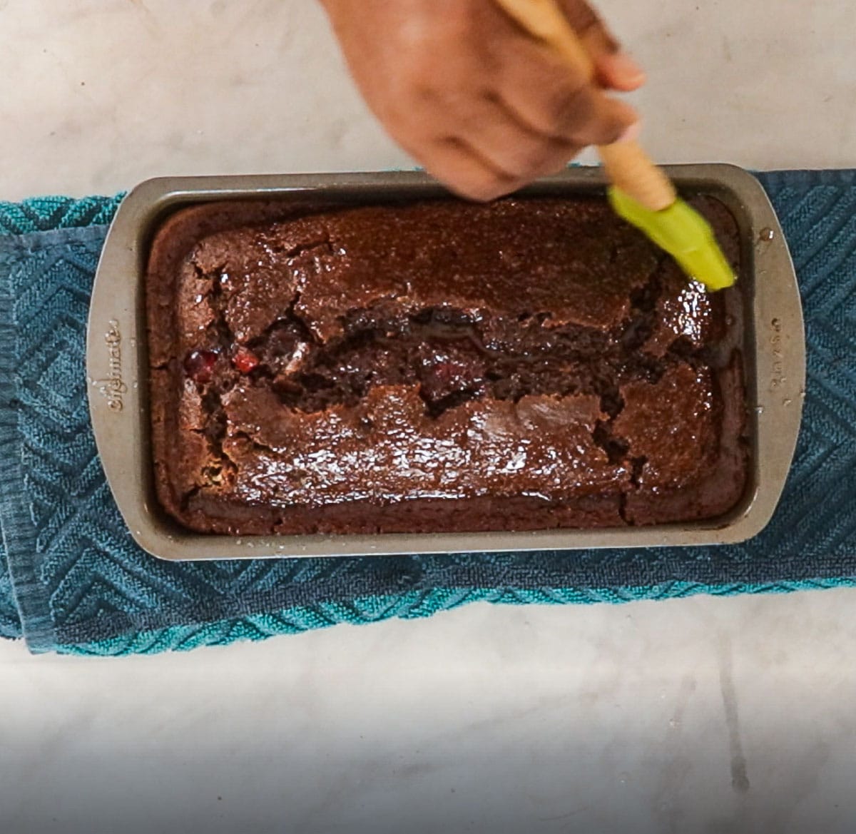 brushing spice bread with pastry brush