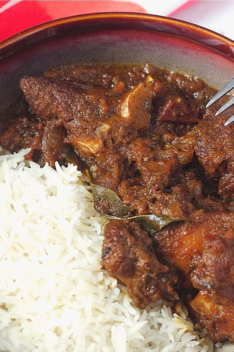 Nellore Mutton Curry with rice in a bowl.