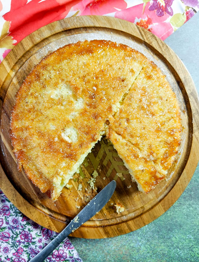 Haitian Orange Cake with a knife and 1 slice cut out