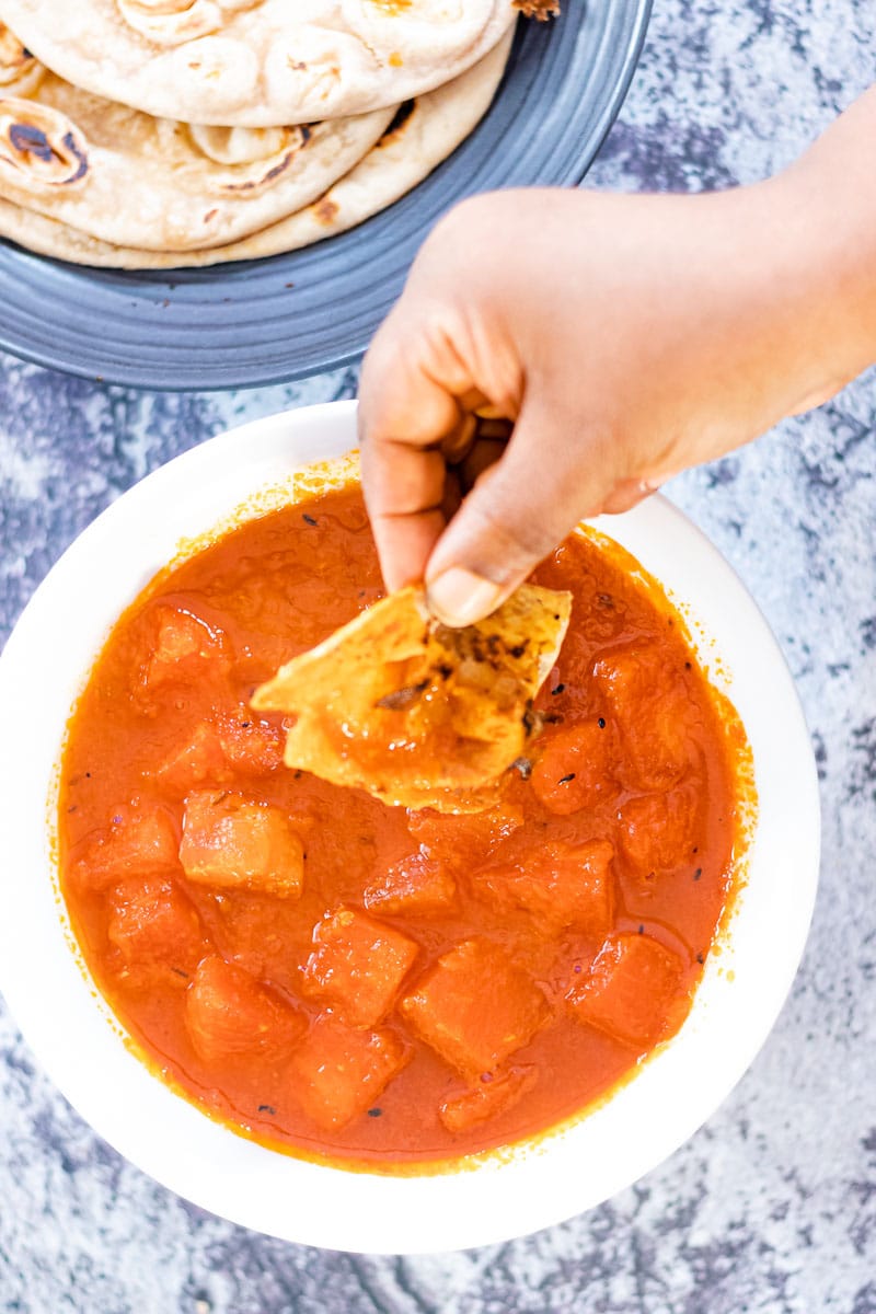 bowl of Watermelon Curry with piece of paratha