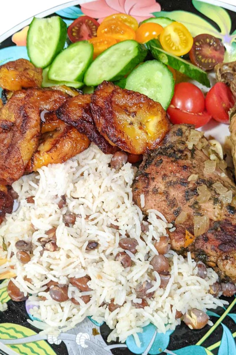 Caribbean dinner plate with Creole Baked Chicken, Rice and Peas, Salad and Fried Ripe Plantain