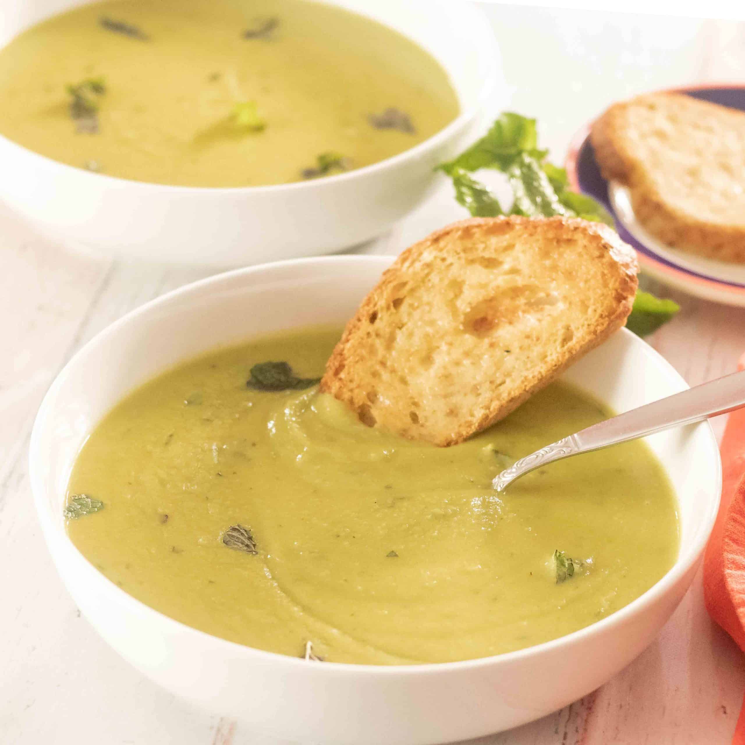 Fresh Green Pea Soup Recipe with Mint and Crusty bread in a bowl