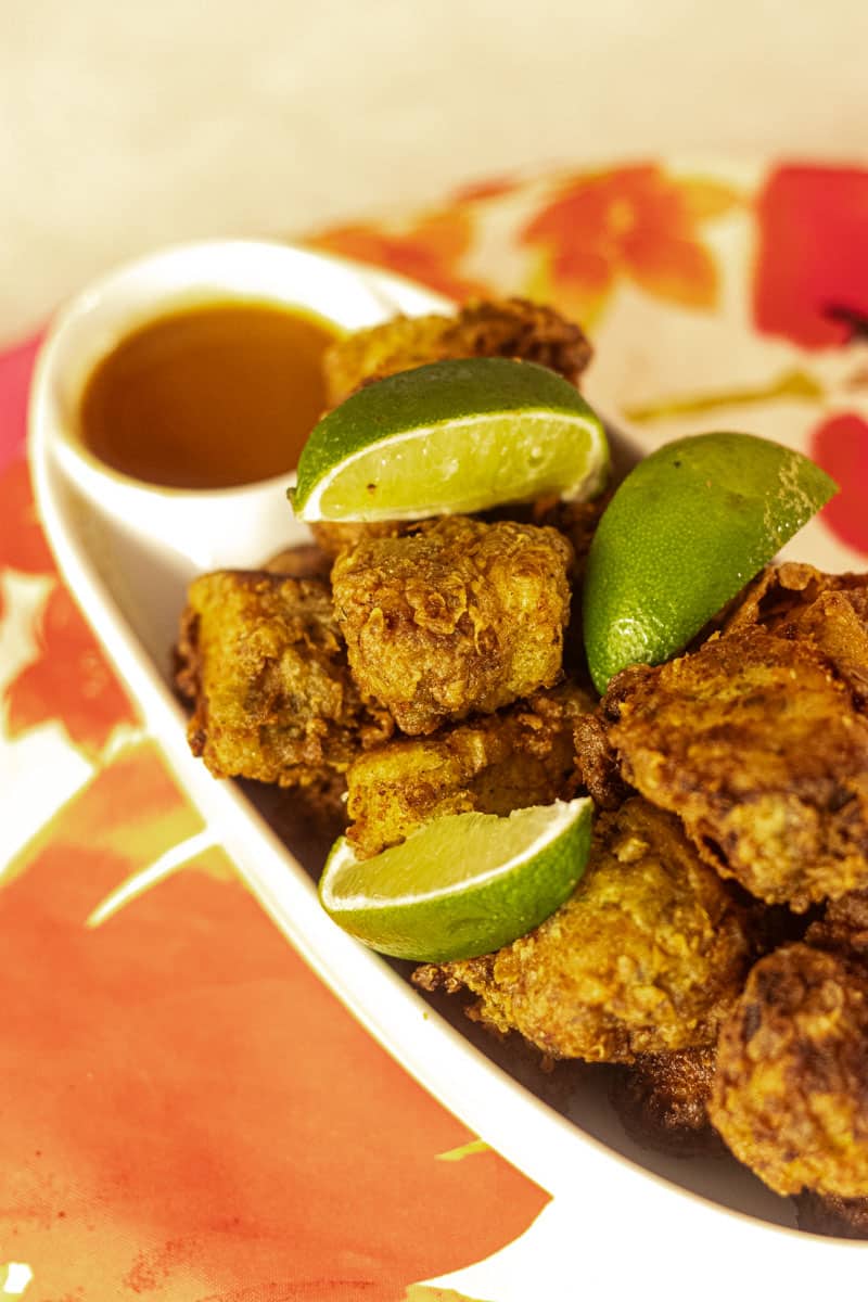 Fried Shark recipe with lime wedges and hot sauce